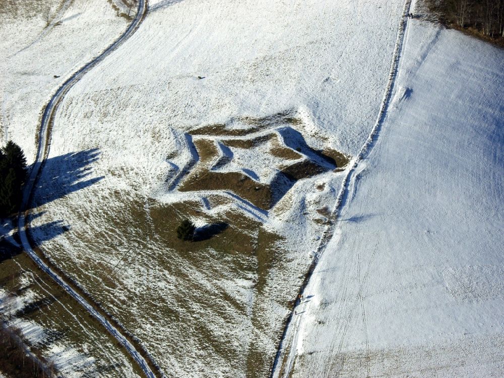 Kleines Wiesental from the bird's eye view: Like a Christmas star, the wintry snowy star shaped remains of the fortifications in the Black Forest in the district Neuenweg in Kleines Wiesental in the state of Baden-Wuerttemberg