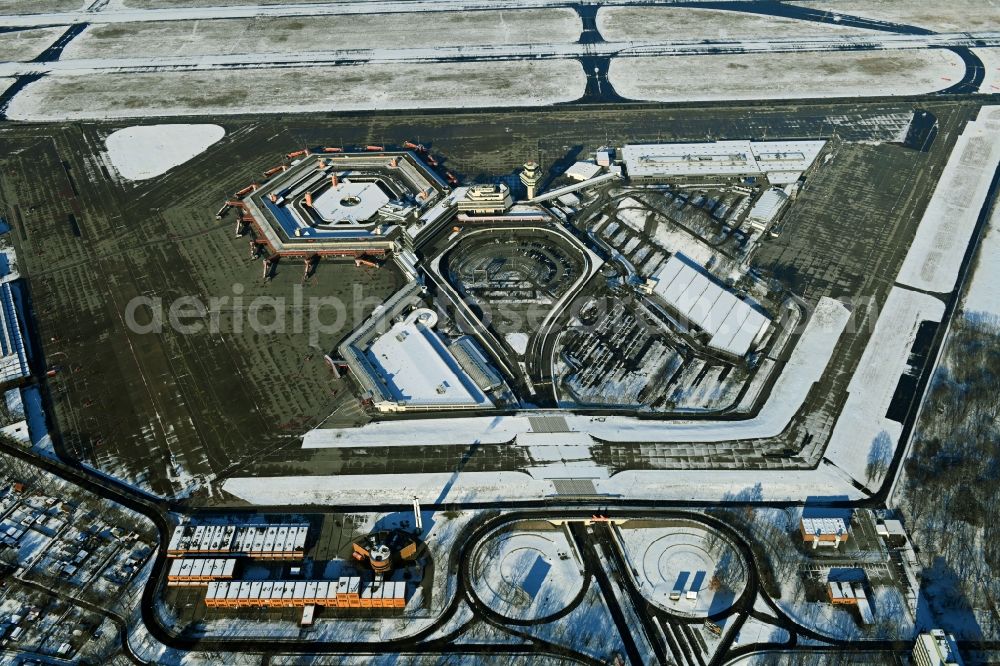 Berlin from the bird's eye view: Wintry snowy end of flight operations at the terminal of the airport Berlin - Tegel