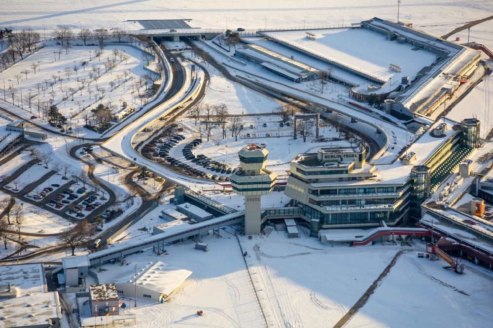 Berlin from the bird's eye view: Wintry snowy end of flight operations at the terminal of the airport Berlin - Tegel
