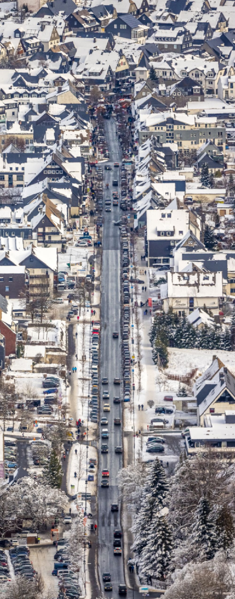 Winterberg from above - Wintry snowy street guide of famous promenade and shopping street on street Am Waltenberg in Winterberg at Sauerland in the state North Rhine-Westphalia, Germany