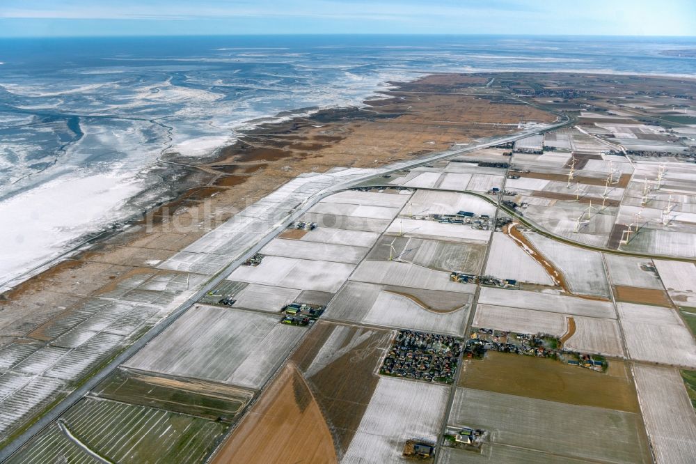 Kaiser-Wilhelm-Koog from the bird's eye view: Wintry snowy structures on agricultural fields at the North Sea coast in Kaiser-Wilhelm-Koog in the state Schleswig-Holstein, Germany