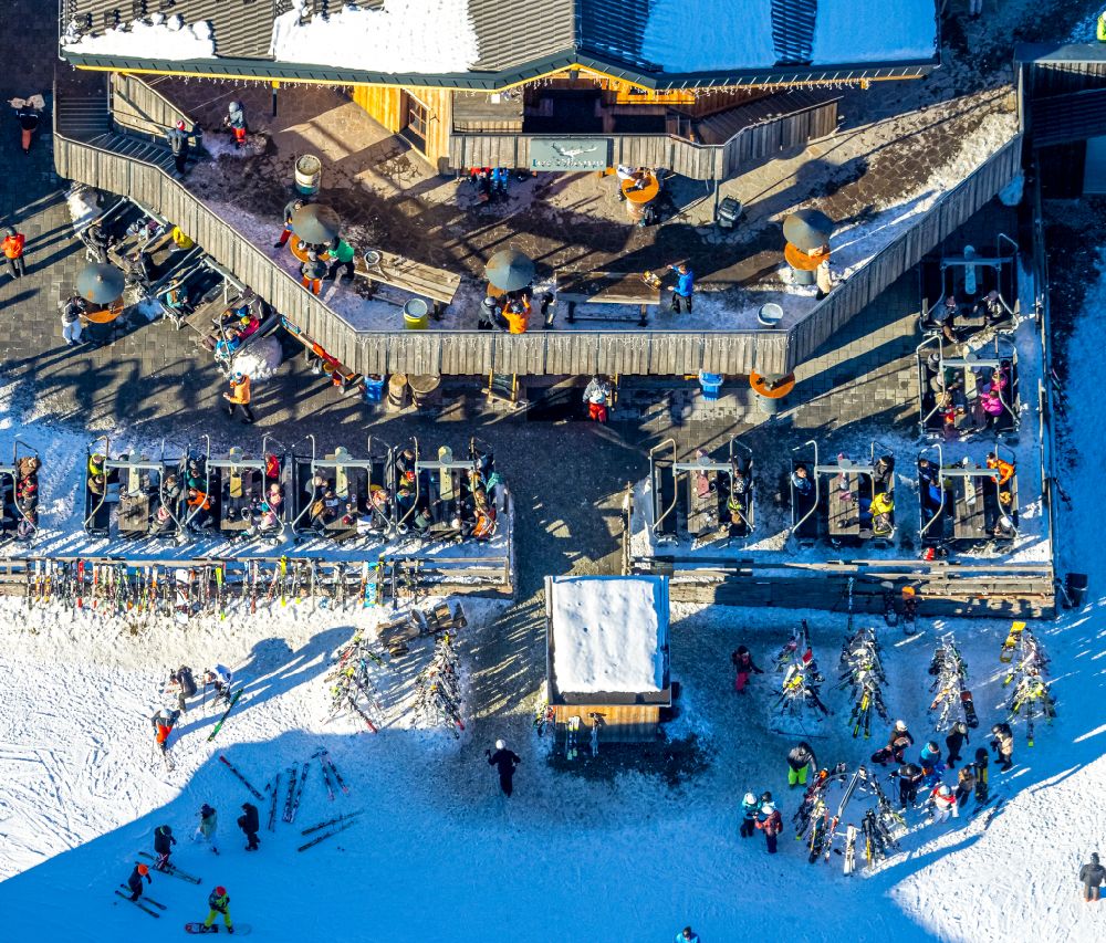 Aerial image Winterberg - Wintry snowy tables and benches of open-air restaurant Restaurant Bei Moeppi on street In der Buere in Winterberg at Sauerland in the state North Rhine-Westphalia, Germany