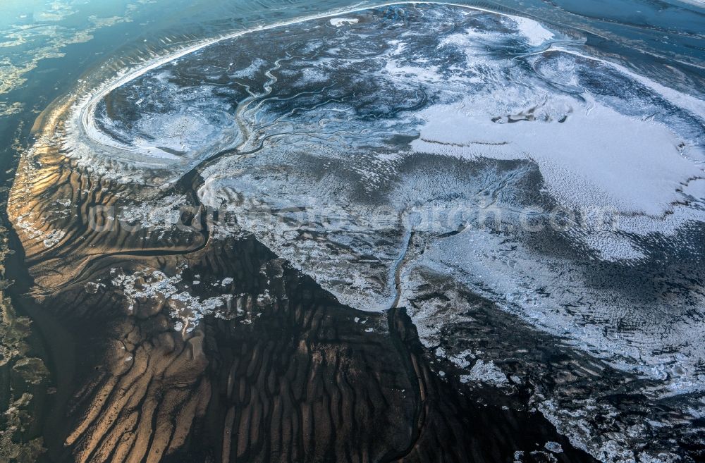 Nordseeinsel Memmert from above - Wintry snow-covered ice floe pieces of a drift ice layer with meanders on the water surface on the North Sea island of Memmert in the state of Lower Saxony, Germany