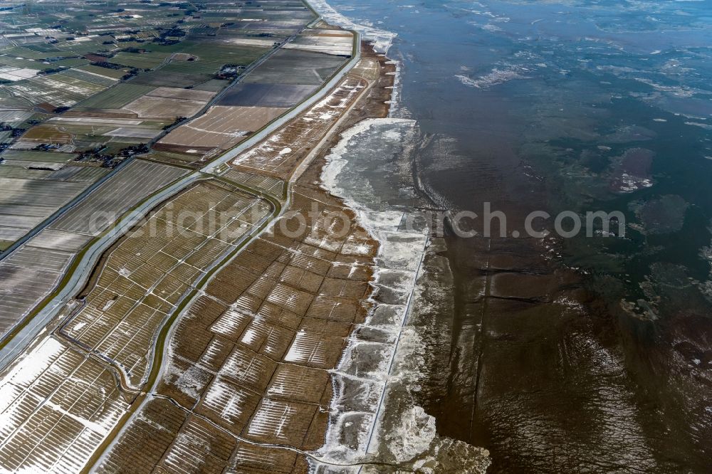 Aerial image Nessmersiel - Wintry snowy ice floe pieces of a drift ice layer on the water surface vor of Nordsee- Kueste in Nessmersiel in the state Lower Saxony, Germany