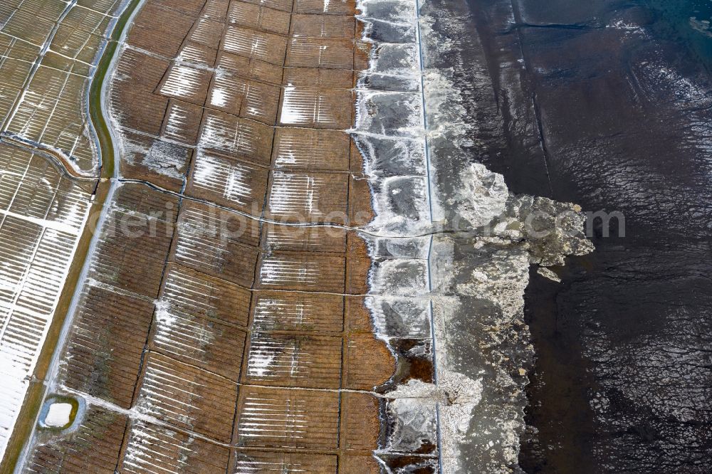 Aerial photograph Nessmersiel - Wintry snowy ice floe pieces of a drift ice layer on the water surface vor of Nordsee- Kueste in Nessmersiel in the state Lower Saxony, Germany