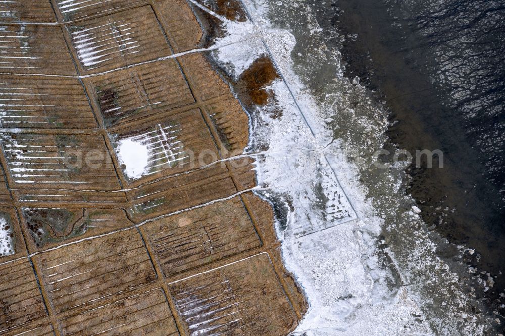 Nessmersiel from above - Wintry snowy ice floe pieces of a drift ice layer on the water surface vor of Nordsee- Kueste in Nessmersiel in the state Lower Saxony, Germany