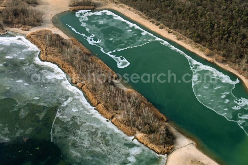 Berlin from above - Shore areas frozen in winter at the Kaulsdorfer Seen lake area in the Kaulsdorf district in Berlin, Germany