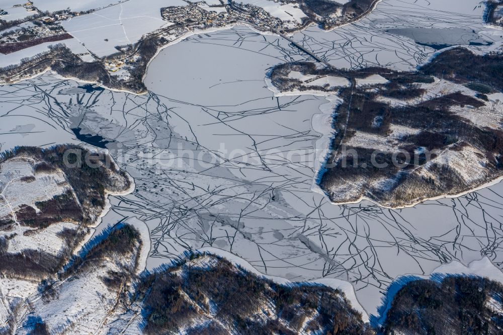Möhnesee from above - Wintry snowy riparian areas on the lake area of Moehnesee in Moehnesee in the state North Rhine-Westphalia, Germany