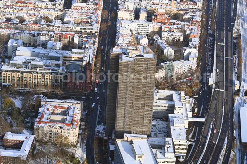 Berlin from the bird's eye view: Wintry snowy construction site for the reconstruction of the high-rise building and building complex Steglitzer Kreisel - UBERLIN residential tower on Schlossstrasse in the district of Steglitz in Berlin