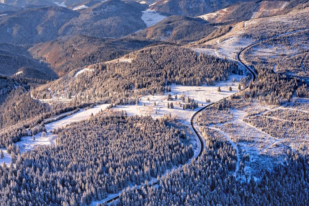 Baiersbronn from the bird's eye view: Wintry snowy forest and mountain scenery along the federal street B500 in the district Klosterreichenbach in Baiersbronn in the state Baden-Wuerttemberg
