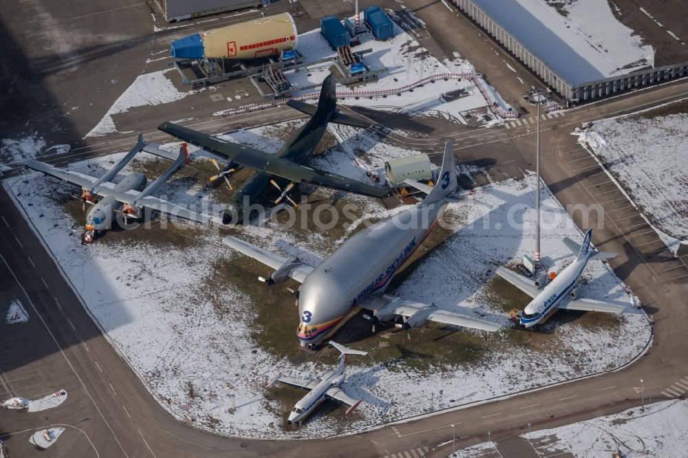Hamburg from the bird's eye view: Wintry snowy shipyard of the aeronautical company Airbus SE with historic transport aircraft in the district Finkenwerder in Hamburg, Germany