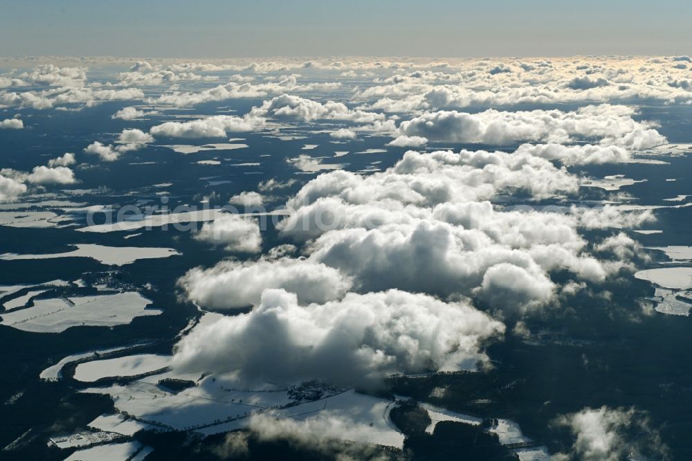 Aerial photograph Userin - Wintry snowy weather conditions with cloud formation over forest areas in Userin in the state Mecklenburg - Western Pomerania, Germany