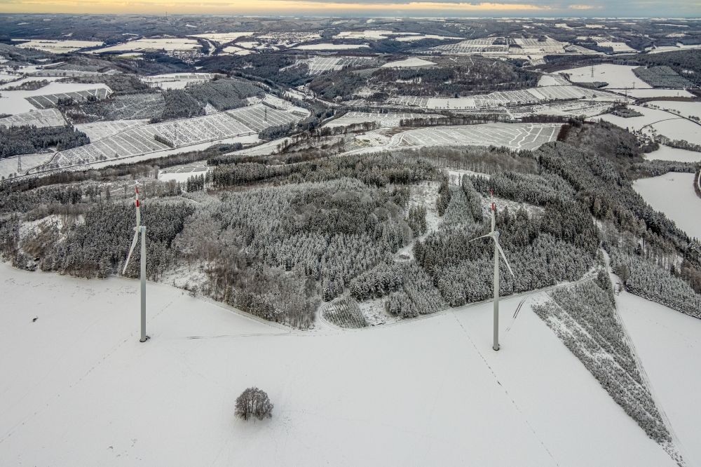 Berlar from the bird's eye view: Wintry snowy wind turbine windmills on a field in Berlar in the state North Rhine-Westphalia, Germany