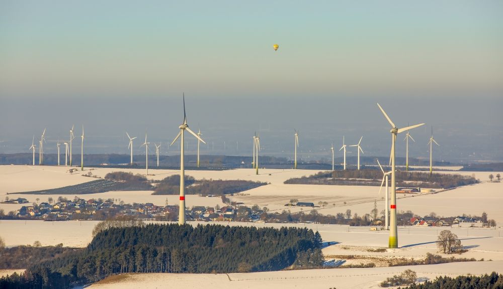 Aerial photograph Rüthen - Wintry snowy Wind turbine windmills on a field in the district Kallenhardt in Ruethen in the state North Rhine-Westphalia