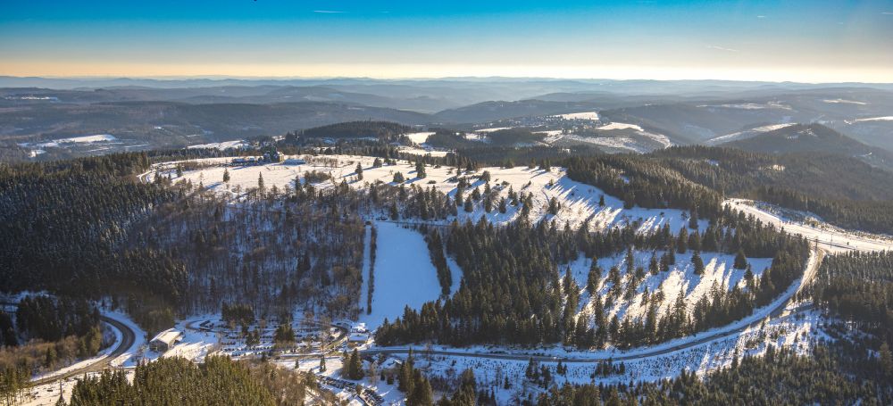 Aerial image Winterberg - Wintry snowy aisle and downhill slope in the winter sports ski area in Winterberg at Sauerland in the state North Rhine-Westphalia, Germany