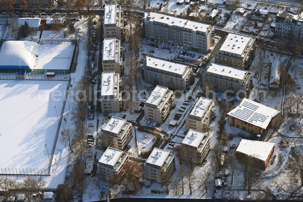 Berlin from above - Wintry snowy residential area of a multi-family house settlement on the bank and river of Spree River on street Bruno-Buergel-Weg in the district Schoeneweide in Berlin, Germany