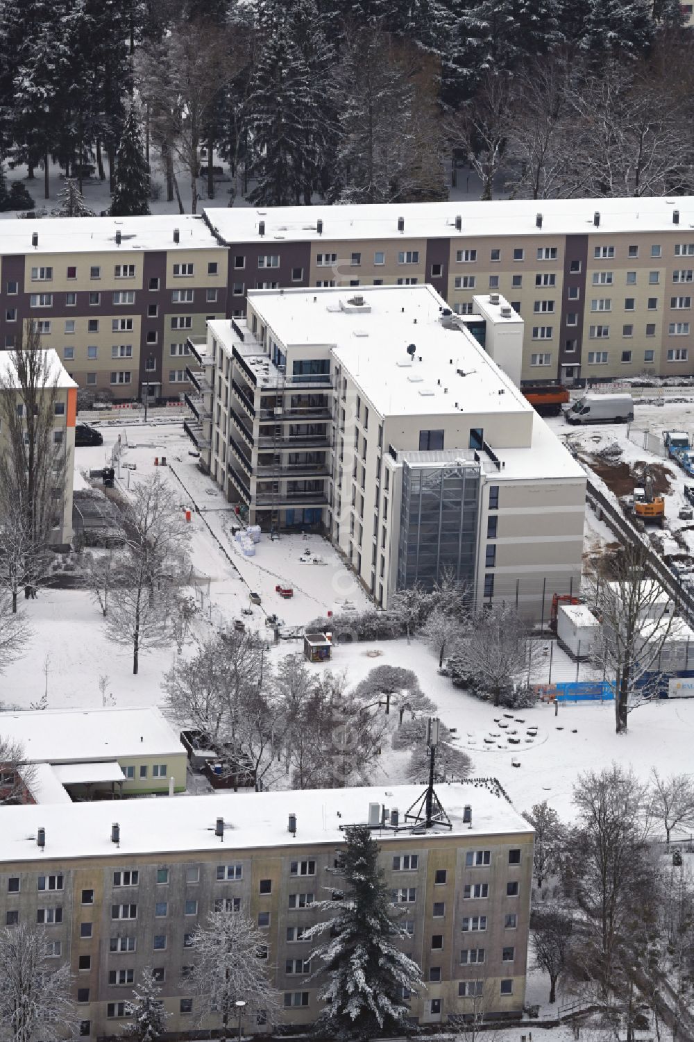Aerial image Bernau - Wintry snowy construction site of Dorm residential care home - building for the physically handicapped on Hermann-Duncker-Strasse in Bernau in the state Brandenburg, Germany