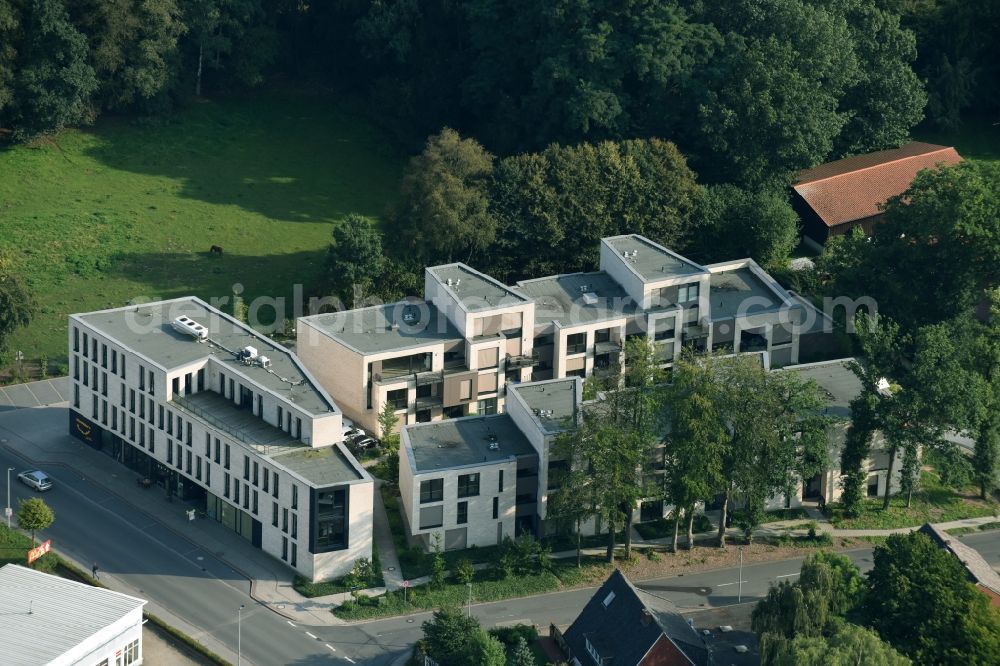Cloppenburg from the bird's eye view: Residential and commercial building Schuetzenstrasse - Emsteker street in Cloppenburg in the state Lower Saxony. In the picture is a bakery