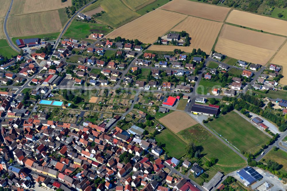 Neubrunn from the bird's eye view: Single-family residential area of settlement on the edge of agricultural fields in Neubrunn in the state Bavaria, Germany