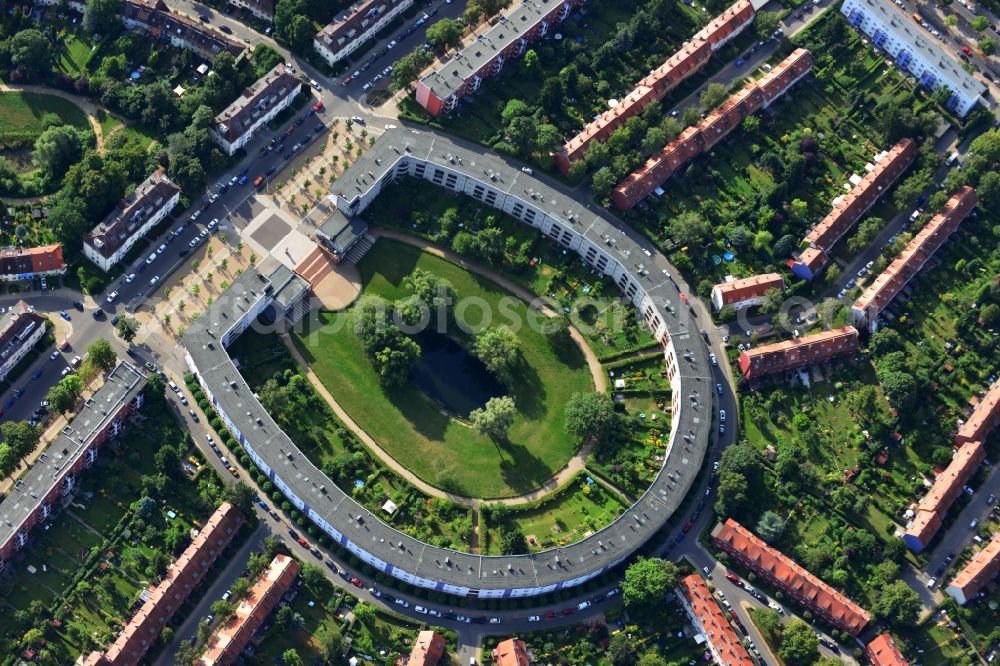 Berlin from above - View of Horseshoe settlement in Berlin-Britz. The Hufeisensiedlung was builded from 1925 to 1933 in Berlin-Britz, designed by Bruno Taut and Martin Wagner. It is one of the first projects of social housing and part of the large settlement Britz / Fritz Reuter city. Since 2008 it has been a UNESCO World Heritage Site. The horseshoe itself is still owned by the GEHAG, under the roof of the Deutsche Wohnen AG