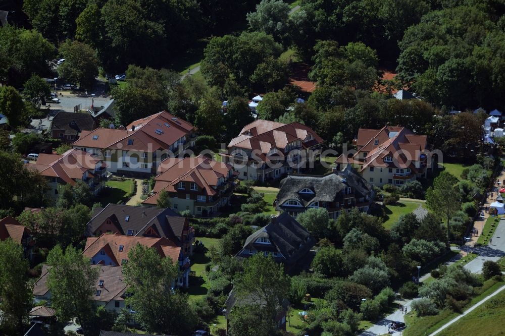 Wustrow from the bird's eye view: Residential area in Wustrow in the state of Mecklenburg - Western Pomerania. The area includes residential homes, single family houses, hotels and holiday apartments and is located in the West of the village, surrounded by trees and forest
