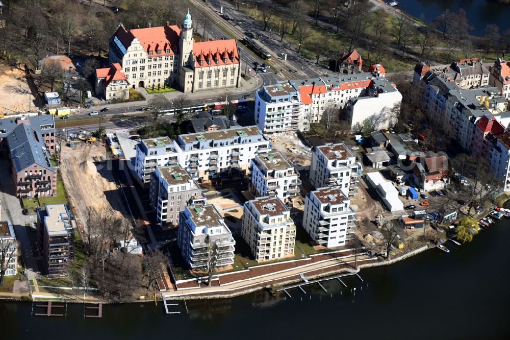 Berlin from above - Wintry snowy residential estate on the riverbank of the river Spree in the Koepenick part of the district of Treptow-Koepenick in Berlin in Germany. The estate includes apartments and flats and is located right on the river on Lindenstrasse