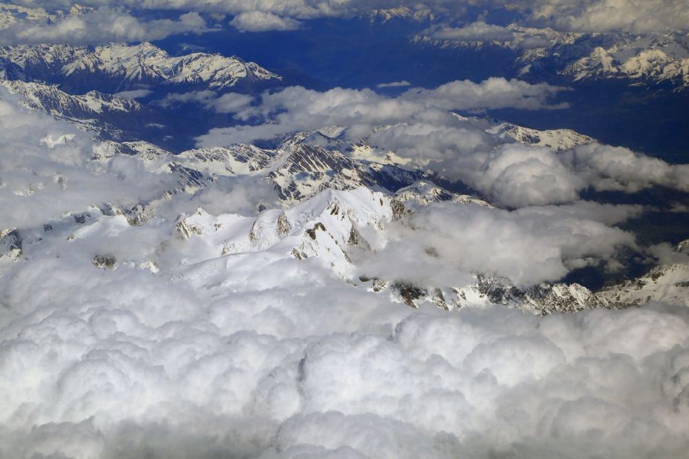 Aerial image Chamonix-Mont-Blanc - Clouds over the rock and mountain landscape in the high alps in Chamonix-Mont-Blanc in Auvergne-Rhone-Alpes, France