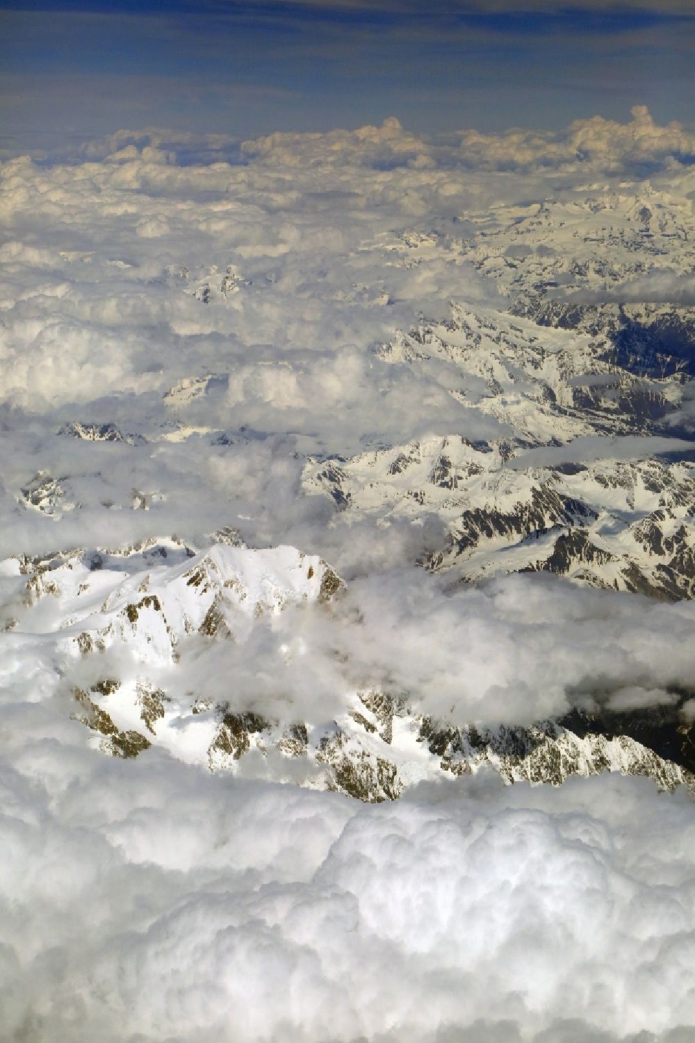 Chamonix-Mont-Blanc from above - Clouds over the rock and mountain landscape in the high alps in Chamonix-Mont-Blanc in Auvergne-Rhone-Alpes, France