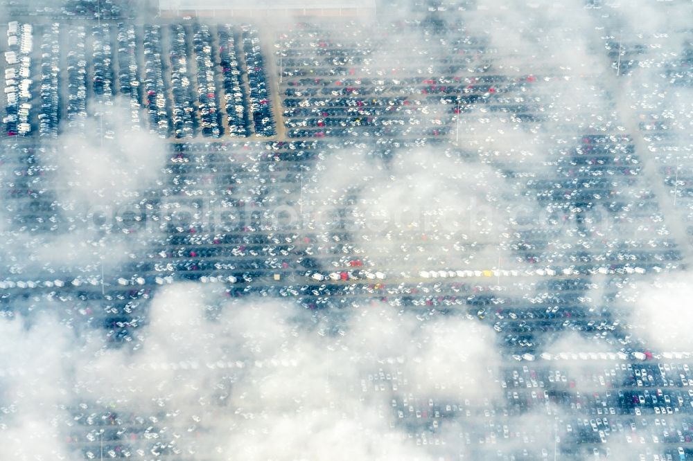 Kippenheim from the bird's eye view: Clouds and fog over the parking and storage space for automobiles in Kippenheim in the state Baden-Wurttemberg, Germany