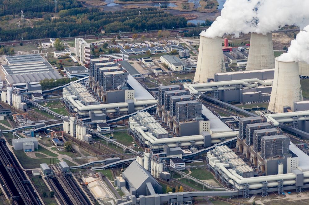 Teichland from the bird's eye view: Clouds of exhaust gas in the cooling towers of the power plant Jaenschwalde, a lignite-fired thermal power plant in southeastern Brandenburg. Power plant operator is to Vattenfall Europe belonging Vattenfall Europe Generation AG, which emerged from VEAG