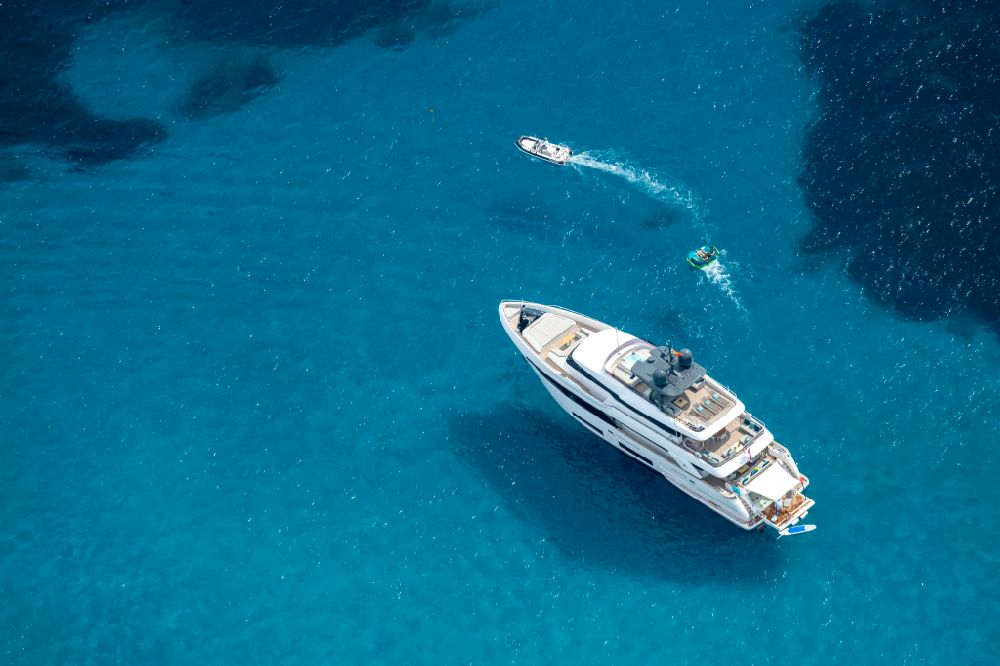 Aerial image Peguera - Luxury yacht on the sea on the water surface in on street Carrer Passerells in Peguera in Balearic islands, Spain