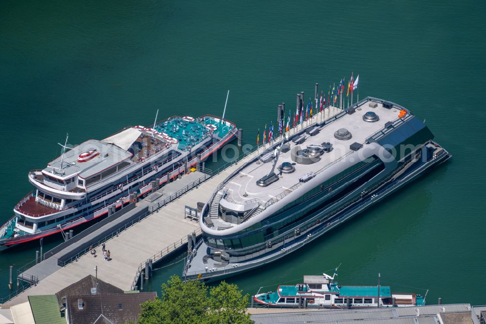 Bregenz from above - Luxury yacht on the water surface on the quay and docks of the inland port on the shore of Lake Constance on street Seestrasse in Bregenz at Bodensee in Vorarlberg, Austria