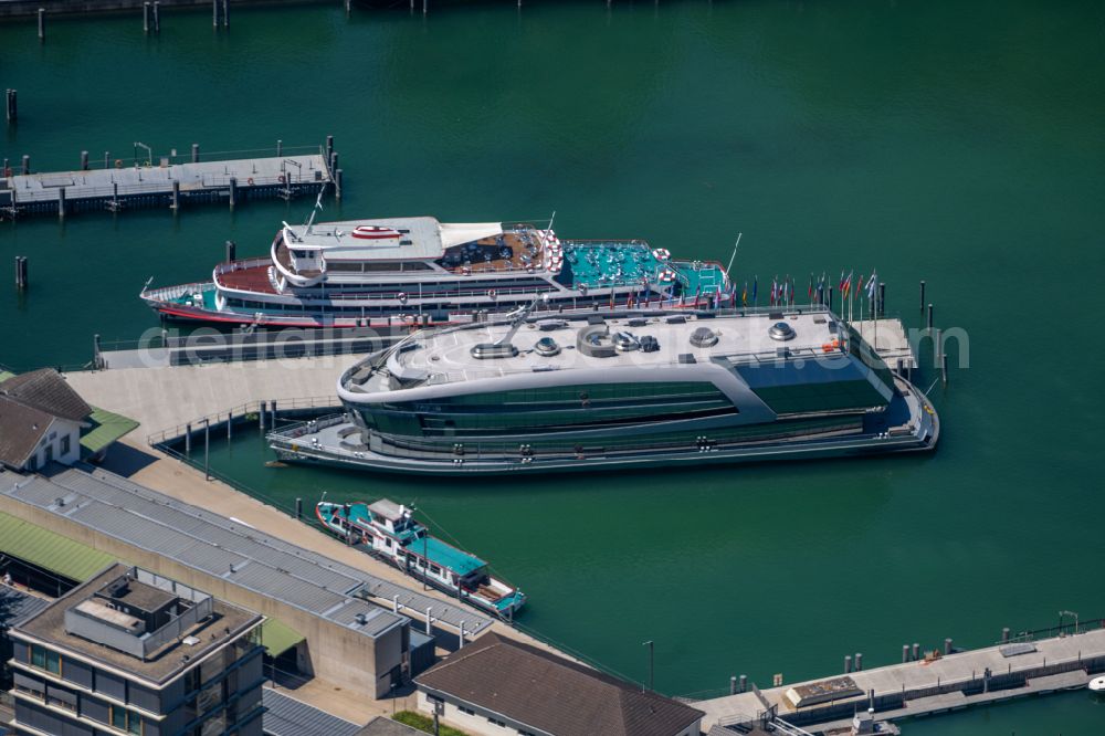 Bregenz from the bird's eye view: Luxury yacht on the water surface on the quay and docks of the inland port on the shore of Lake Constance on street Seestrasse in Bregenz at Bodensee in Vorarlberg, Austria
