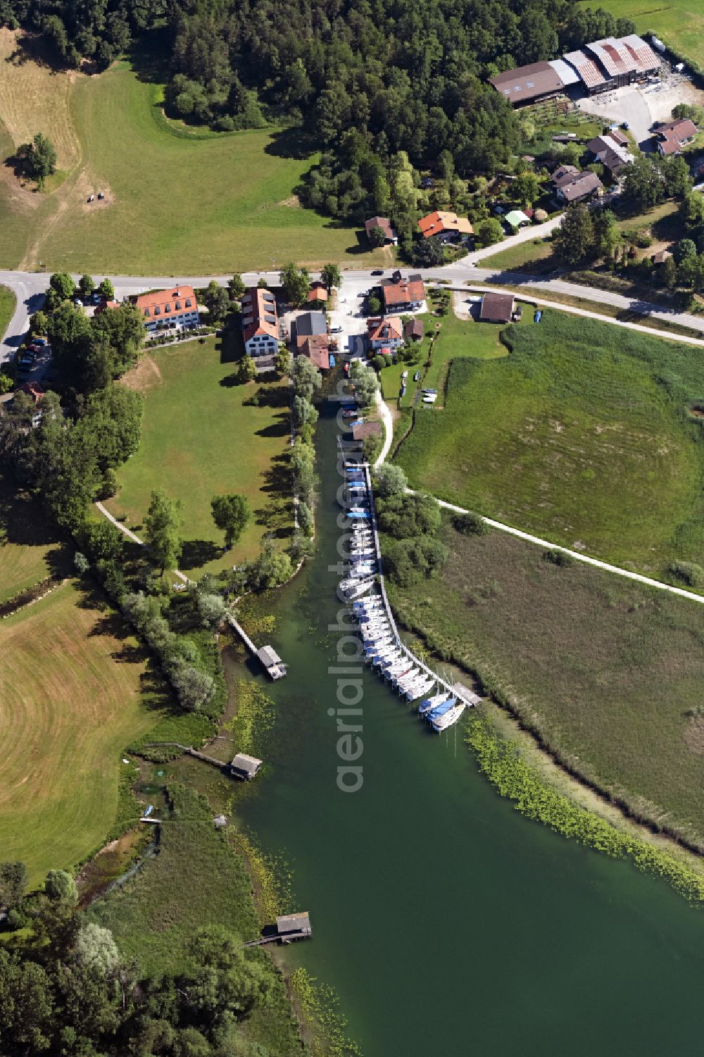 Rimsting from above - Pleasure boat marina Kreuzmeier with docks and moorings on the shore area of Chiemsee on street Aiterbach in Rimsting in the state Bavaria, Germany