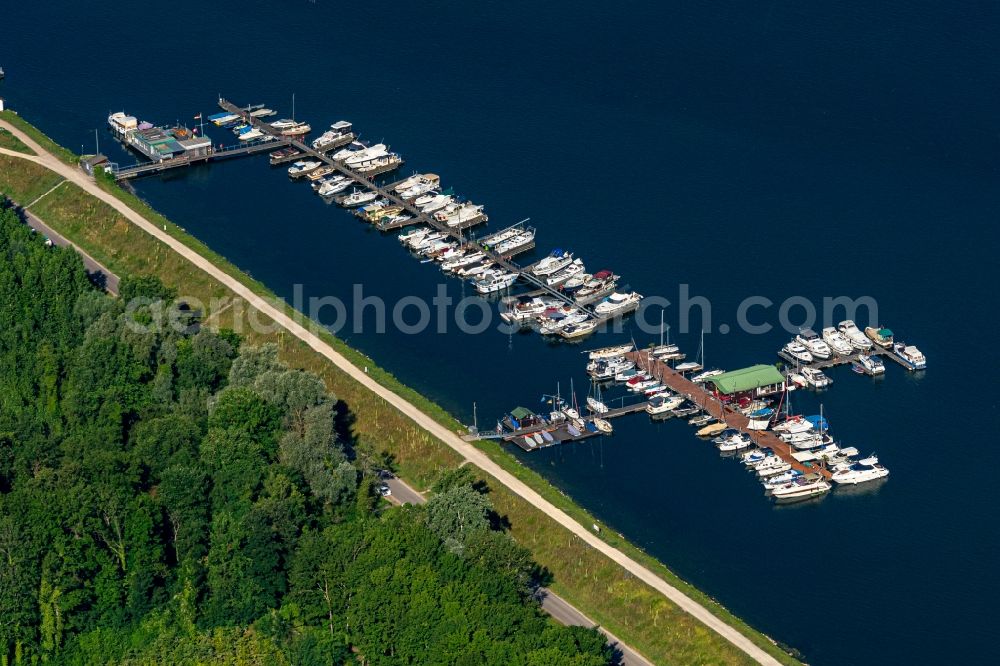 Weisweil from the bird's eye view: Pleasure boat marina with docks and moorings on the shore area on Rhein in Weisweil in the state Baden-Wurttemberg, Germany