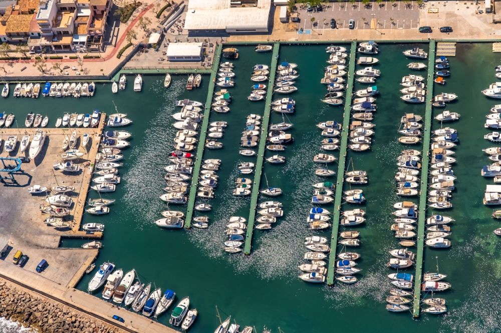 Aerial image Can Picafort - Pleasure boat marina with docks and moorings on the shore area on Carrer Cervantes in Can Picafort in Balearic island of Mallorca, Spain