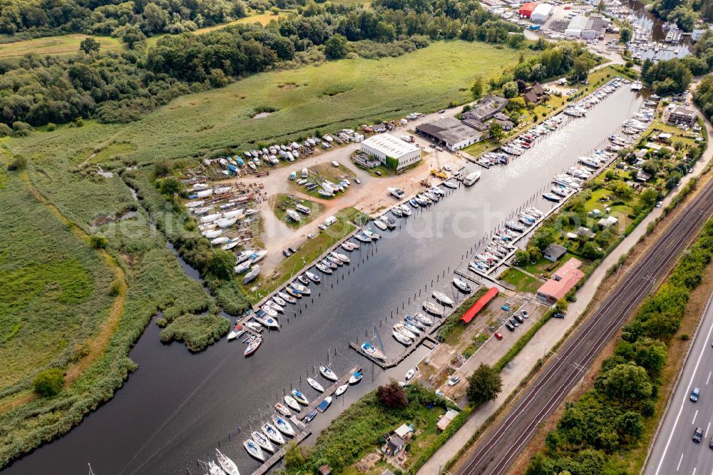Bad Schwartau from the bird's eye view: Pleasure boat marina with docks and moorings on the shore area of Trave in Bad Schwartau in the state Schleswig-Holstein, Germany