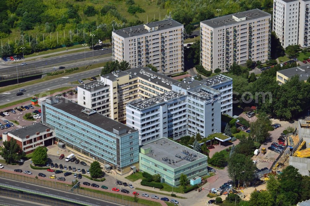 Aerial image Warschau - Central Institute for Labour Protection in the Czerniakow part of the district of Mokotow in Warsaw in Poland. The building is located on the motorway E30 (A2) and the North to South running Czerniakowska Street in the East of the district. It is surrounded by residential appartment buildings and a construction site. The Institute is located in the building complex, its logo is located on the building front