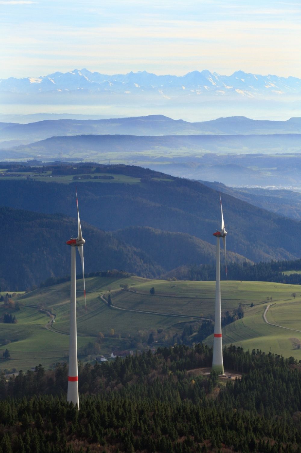 Schopfheim from the bird's eye view: Looking over two wind turbines of the wind farm Rohrenkopf in the Southern Black Forest in Gersbach, Baden-Wuerttemberg. Looking southbound to the Swiss Alps