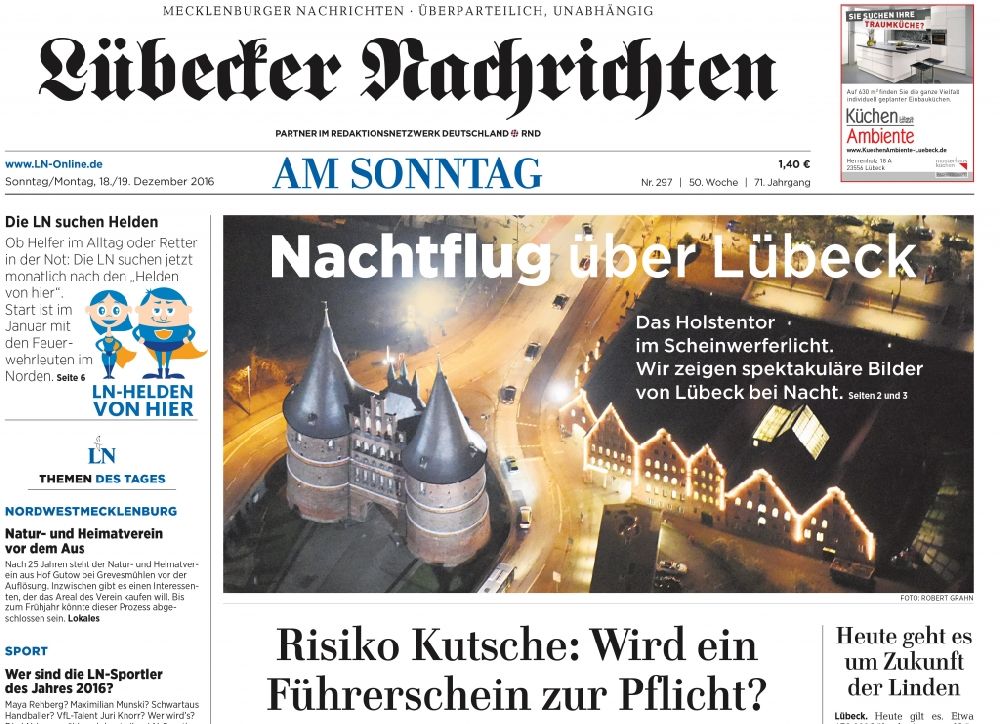 Lübeck at night from above - Picture Section / media use of aerial use in the Newspaper - daily paper Luebecker Nachrichten Luebecker News Titelfoto Page 1 Night aerial Holstentor in Luebeck in the state Schleswig-Holstein