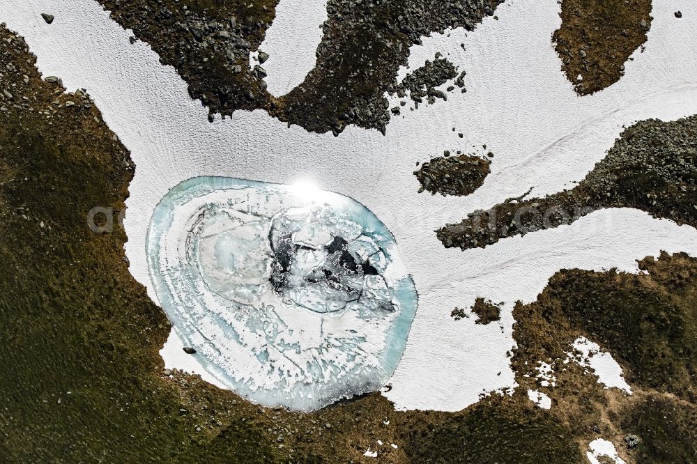 Vertical aerial photograph Mittersill - Vertical aerial view from the satellite perspective of the wintry snowy snowmelt water accumulation in a massif of the Alps in Mittersill in Tirol, Austria