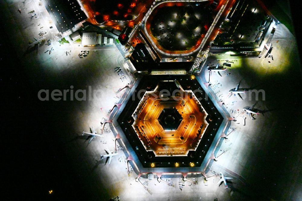 Vertical aerial photograph Berlin - Vertical aerial view from the satellite perspective of the Night lighting Flight operations at the terminal of the airport Berlin - Tegel