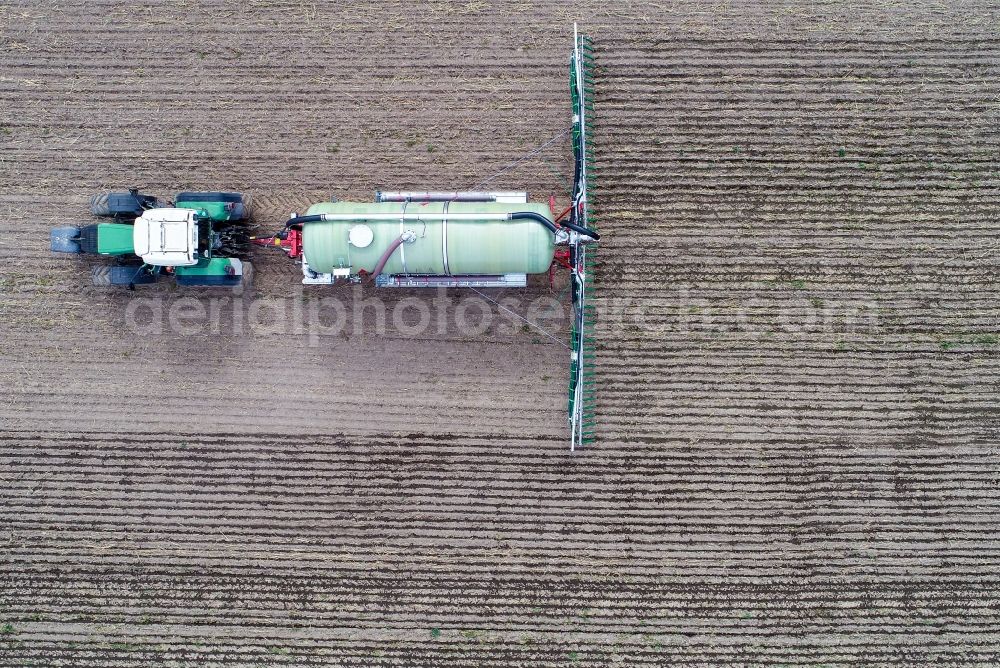 Vertical aerial photograph Sieversdorf - Vertical aerial view from the satellite perspective of the farm equipment used for fertilizing fields in Sieversdorf in the state Brandenburg, Germany