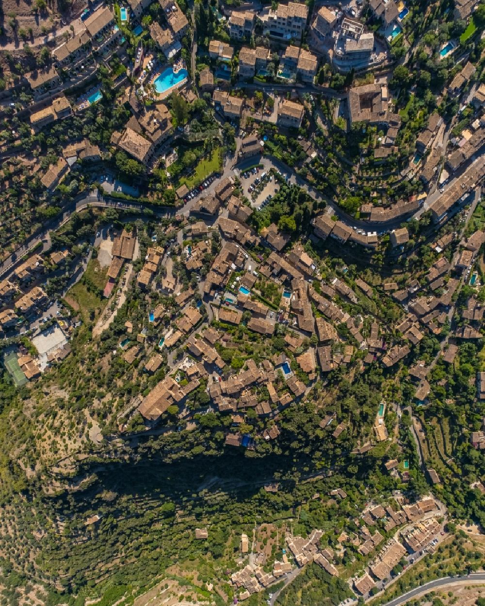 Vertical aerial photograph Deia - Vertical aerial view from the satellite perspective of the location view of the streets and houses of residential areas in the valley landscape surrounded by mountains and forest in Deia in Balearic island of Mallorca, Spain