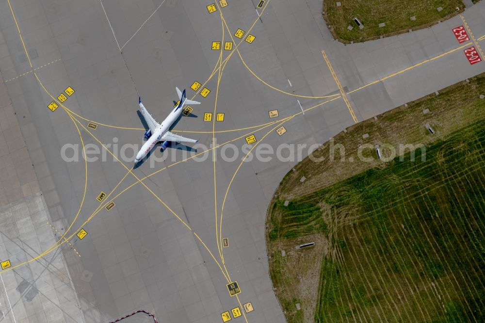 Vertical aerial photograph Filderstadt - Vertical aerial view from the satellite perspective of the passenger jet Boeing 737-800 with the registration TC-JFD of the airline Anadolu taxiing on the tarmac and apron of the Stuttgart airport in Filderstadt in the state Baden-Wuerttemberg, Germany