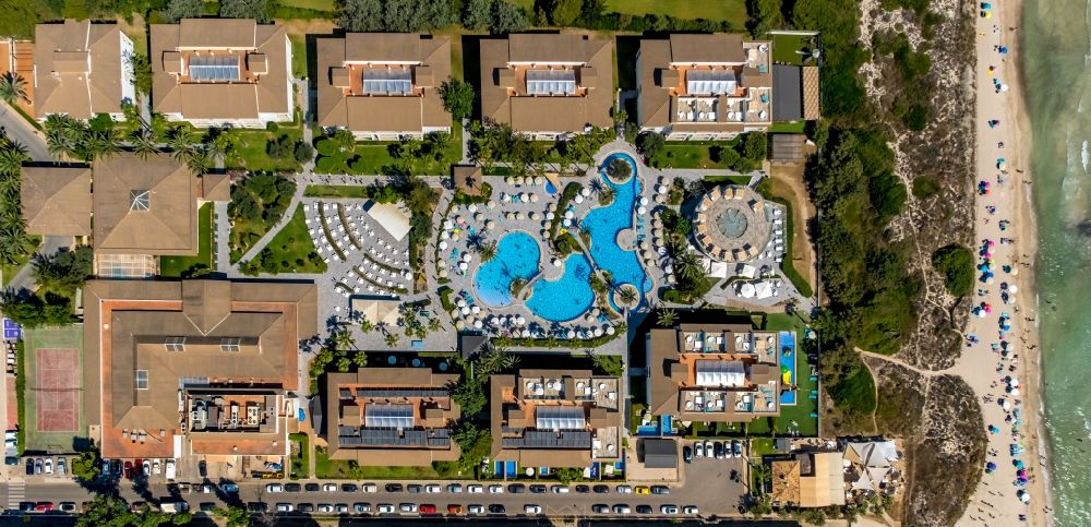Vertical aerial photograph Can Picafort - Vertical aerial view from the satellite perspective of the refreshing swim in the blue pool - swimming pool of the hotel Playa Garden Selection Hotel & Spa on Avenida Platges de Muro in Can Picafort in Balearic island of Mallorca, Spain