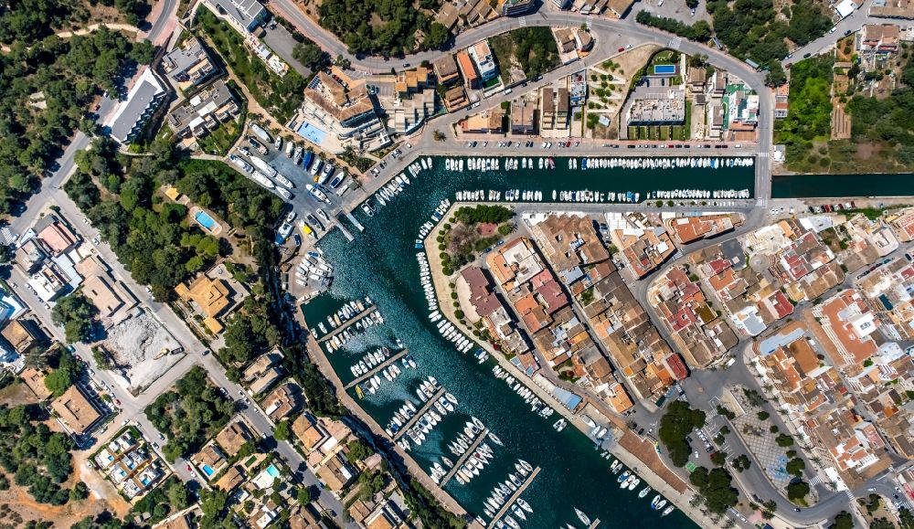 Vertical aerial photograph Manacor - Vertical aerial view from the satellite perspective of the pleasure boat marina with docks and moorings on the shore area Cala Manacor in Manacor in Balearic island of Mallorca, Spain