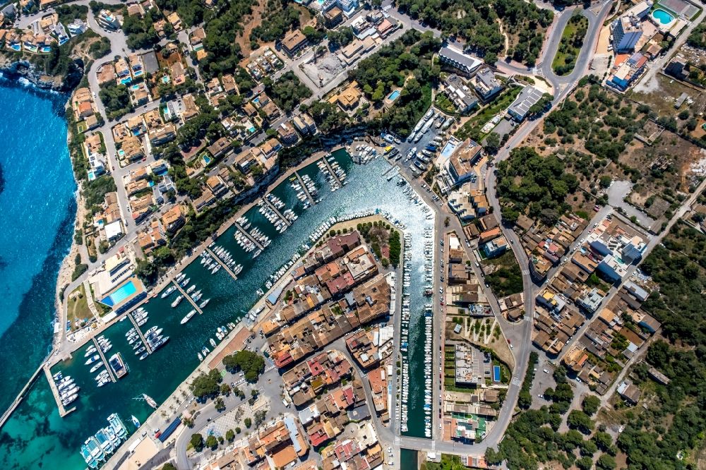 Vertical aerial photograph Manacor - Vertical aerial view from the satellite perspective of the pleasure boat marina with docks and moorings on the shore area Cala Manacor in Manacor in Balearic island of Mallorca, Spain