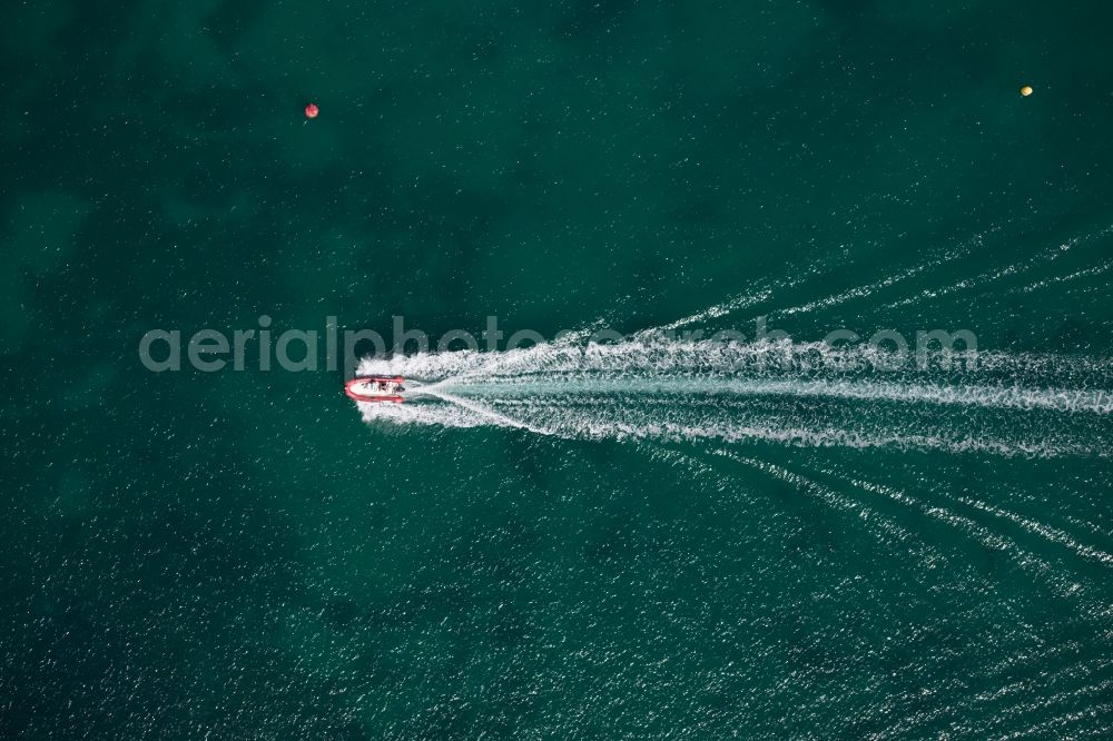 Vertical aerial photograph Colònia de Sant Jordi - Vertical aerial view from the satellite perspective of the Sport Boat - Dinghy in motion on the water surface offshore in ColA?nia de Sant Jordi in Balearic Islands, Spain