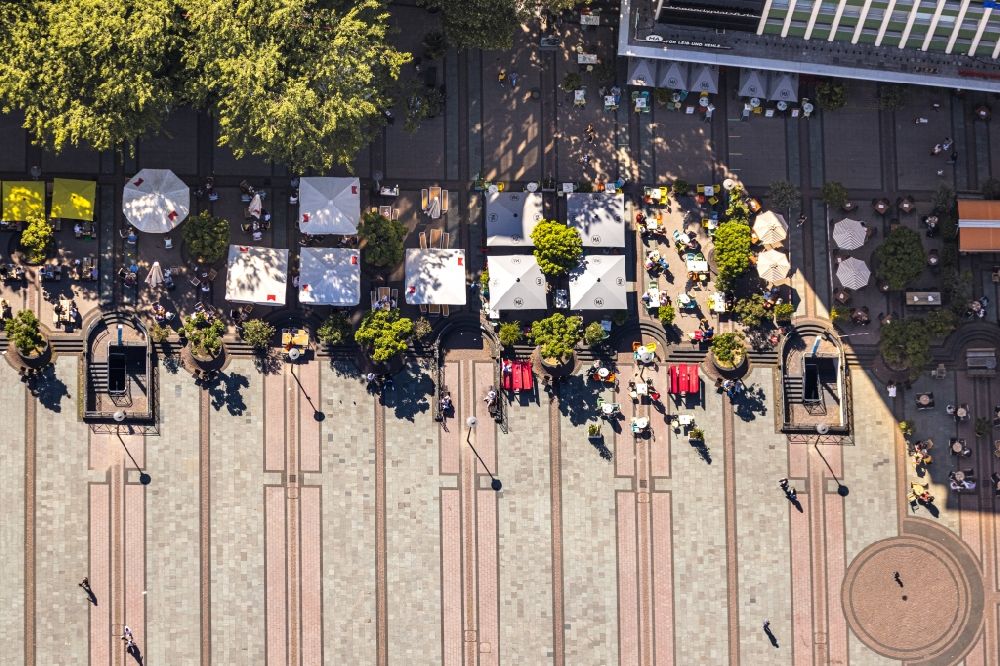 Vertical aerial photograph Essen - Vertical aerial view from the satellite perspective of the tables and benches of open-air restaurants Cafe Extrablatt on Kennedyplatz in Essen in the state North Rhine-Westphalia, Germany